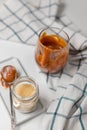 Homemade salted caramel in a glass jar. Delicious sauce with sea salt for ice cream and desserts. Selective focus Royalty Free Stock Photo