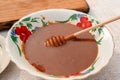 Homemade salted caramel sauce in Bowl with Spoon on table