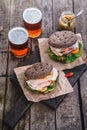 Homemade sandwich with ham and a glass of beer on an old background, top view Royalty Free Stock Photo