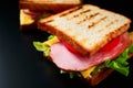 Homemade sandwich with lettuce and ham on a black background, close up Royalty Free Stock Photo