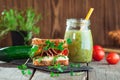 Homemade sandwich with radish sprouts on rustic wooden background