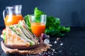 Homemade sandwich with salad and juice as a healthy breakfast Royalty Free Stock Photo