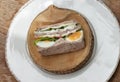 Homemade sandwich stuffed with chicken breast, cheese, boiled eggs and fresh vegetables Royalty Free Stock Photo