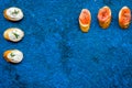 Homemade sandwiches with french baguette, salmon, cheese on blue background top view mock-up