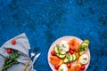 Homemade sandwiches with french baguette, salmon, cheese and vegetable on blue background top view mock-up