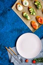 Homemade sandwiches with french baguette, salmon, cheese and vegetable on blue background top view mock-up