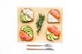 Homemade sandwiches with french baguette, salmon, cheese and vegetable on white background top view