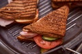 Homemade sandwiches lie on the groa grill