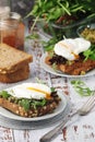 Sandwiches with pesto, poached eggs and green salad