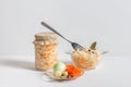 Homemade sauerkraut with carrots in a glass jar and bowl on a white wooden background. Fermented food Royalty Free Stock Photo