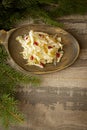 Homemade sauerkraut. Fermented cabbage. Vegan salad rustic style on wooden plate. Traditional rustic winter food