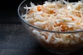 Homemade sauerkraut. Fermented food. Sauerkraut with carrots in a bowl on a wooden background. Top view, flat lay. Close up Royalty Free Stock Photo