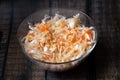 Homemade sauerkraut. Fermented food. Sauerkraut with carrots in a bowl on a wooden background. Top view, flat lay. Close up Royalty Free Stock Photo