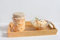 Homemade sauerkraut. Fermented food. Sauerkraut with carrots in a glass jar and bowl in a wooden tray on a white background Royalty Free Stock Photo