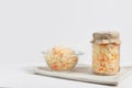 Homemade sauerkraut. Fermented food. Sauerkraut with carrots in glass jar and bowl with fork on wooden white background Royalty Free Stock Photo