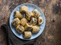 Homemade sausage rolls. Minced puff pastry rolls - delicious snacks, tapas on brown background, top view