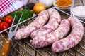 Homemade sausages in a natural shell with spices on grill