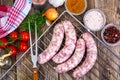 Homemade sausages in a natural shell with spices on grill Royalty Free Stock Photo