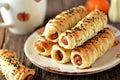 Homemade sausages in puff pastry on wooden background.