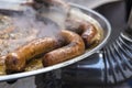 Homemade sausages roasted in barbecue and in oil Royalty Free Stock Photo