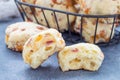 Homemade savory cookies with cheese and bacon in a basket and on table, horizontal Royalty Free Stock Photo