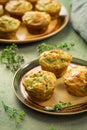 Homemade savory muffins with zucchini and cheese on kitchen table