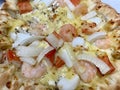 Close-up of stuffed seafood pizza with cheese, onion, prawn, squid, and crab stick. Stuffed crust pizza with Cheese Royalty Free Stock Photo