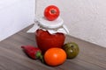 Homemade seasonal preparations. In glass jars, tomato paste. The neck of the cans is wrapped in paper and tied with rope. Nearby