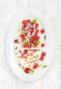 Homemade semifreddo with pistachio, raspberries and mint leaves