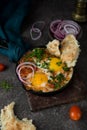 Homemade shakshuka with vegetables on a dark background