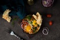 Homemade shakshuka with vegetables on a dark background