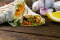 Homemade shawarma, burrito, chicken roll with vegetables and sauce. Front view ingredients, close-up