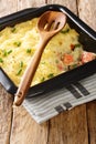 Homemade shepherd salmon pie close-up in a baking dish. vertical