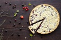 Homemade shortbread berry pie with a slice cut off on wooden table texture. Summer receipts