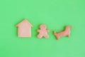 Homemade shortbread cookies on green background, top view. Man and dog near house