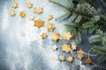 Homemade shortbread star shape sugar with sugar powder and branch of fit-tree on thread over blue texture surface. Selektive focus