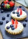 Homemade shortbread tartlets with custard cream, strawberry and blueberry Royalty Free Stock Photo