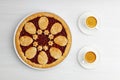 Homemade shortcrust cherry pie and two white cups of coffee espresso on white wooden table. Royalty Free Stock Photo