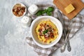 Homemade shrimp and grits with bacon, Chedder cheese and parsley in a white bowl. American cuisine