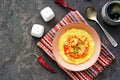 Homemade shrimp and grits with smoked sausages sweet red peppers onions and cheese in a pink bowl on a dark concrete background Royalty Free Stock Photo