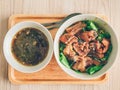 Homemade simple noodle served on wooden plate.