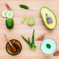 Homemade skin care and body scrub with natural ingredients avocado ,aloe vera ,cucumber and honey set up on wooden background. Royalty Free Stock Photo