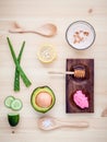 Homemade skin care and body scrub with natural ingredients avocado ,aloe vera ,lemon,cucumber and honey set up on on wooden back Royalty Free Stock Photo