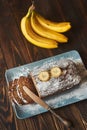 Homemade sliced banana cake decorated with sugar powder and three banana Royalty Free Stock Photo