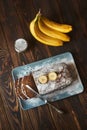 Homemade sliced banana cake decorated with sugar powder and three banana Royalty Free Stock Photo