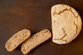 Homemade sliced fresh bread on the wooden background. Just baked round bread on the brown table with free copy space Royalty Free Stock Photo