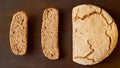 Homemade sliced fresh bread on the wooden background ready to eat. Just baked round bread on the brown table with free copy space Royalty Free Stock Photo