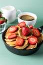 Homemade Small Pancakes with Strawberry Served in Frying Pan Green Background Fresh Pancakes and Cup of Coffee Tasty Breakfast Royalty Free Stock Photo