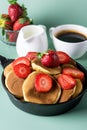 Homemade Small Pancakes with Strawberry Served in Pan Yellow Background Fresh Pancakes and Cup of Coffee Tasty Breakfast Vertical Royalty Free Stock Photo