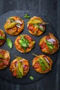 Homemade small pizza with pesto, salami, tomatoes and arugula Royalty Free Stock Photo